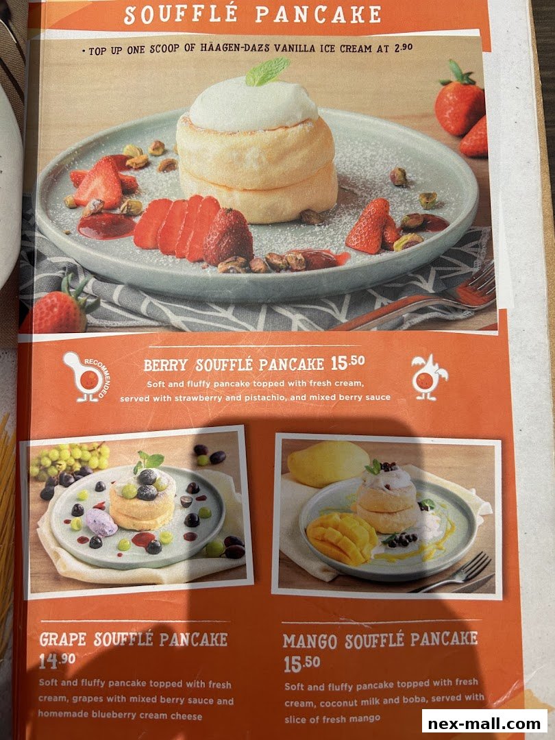 A menu showcasing three varieties of soufflé pancakes: Berry, Grape, and Mango.