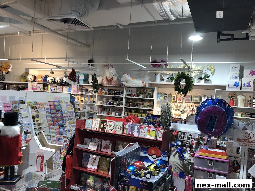 Interior view of a gift shop filled with greeting cards, plush toys, balloons, and festive decorations.