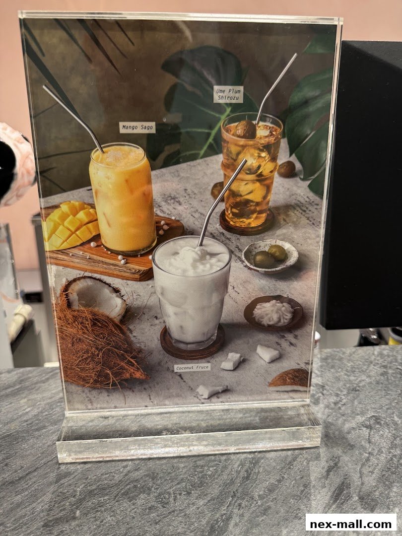A display stand showcasing three refreshing drinks: Mango Sago, Ume Plum Shirozu, and Coconut Fruce.