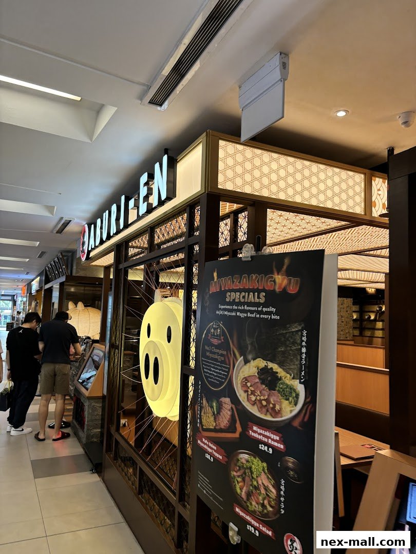 The Aburi-EN Nex shop front with a menu board displaying Miyazaki Wagyu specials.