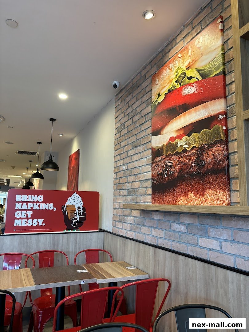 Interior of a Burger King restaurant with tables, chairs, and large burger artwork.
