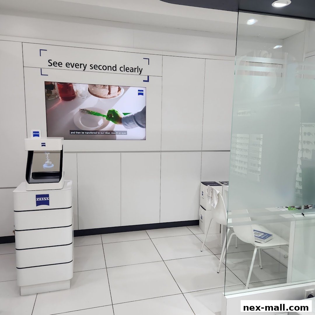 Interior of an optical shop with a digital display and eye examination equipment.