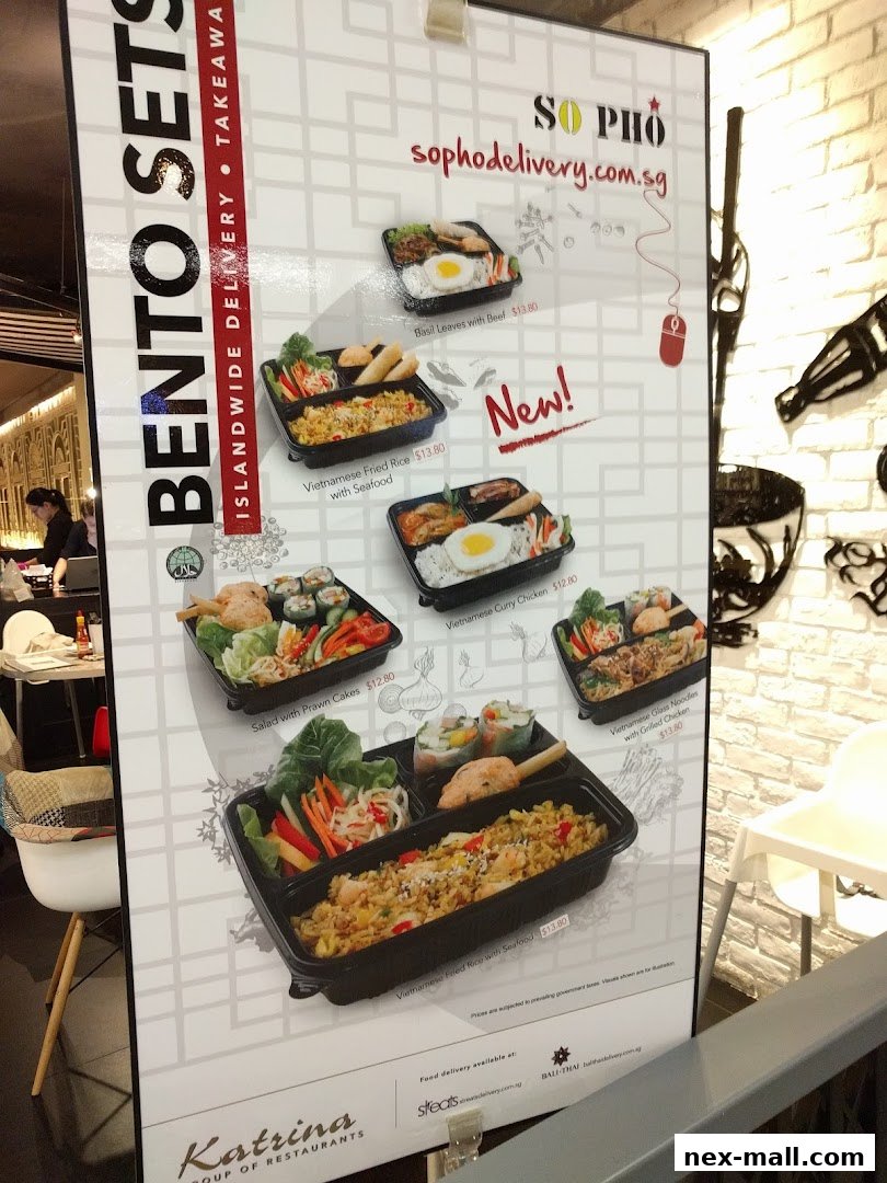 A menu board showcasing various bento sets and Vietnamese dishes with prices.