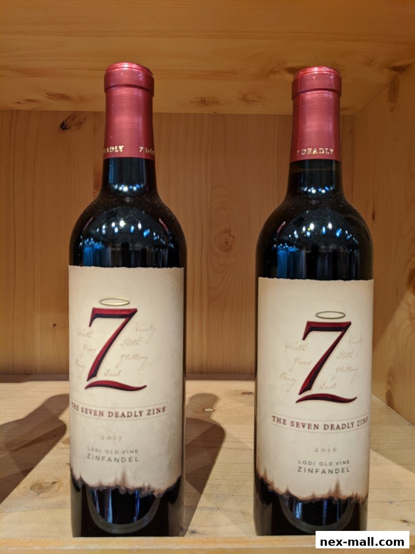 Two bottles of "The Seven Deadly Zins" Zinfandel wine are displayed on a wooden shelf.
