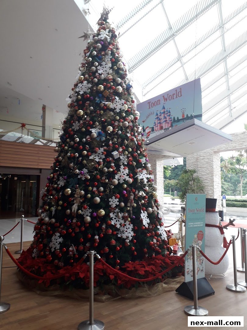 A large, decorated Christmas tree stands in a mall lobby with a 'Toon World' banner.