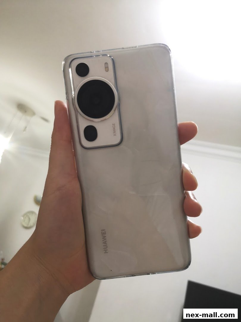 A hand holds a silver Huawei smartphone, showcasing its camera module and branding.