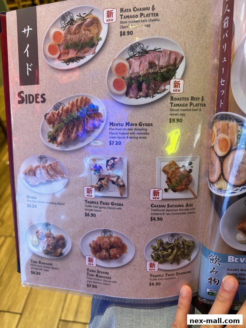 A menu featuring various Japanese side dishes like gyoza, fried chicken, and edamame.