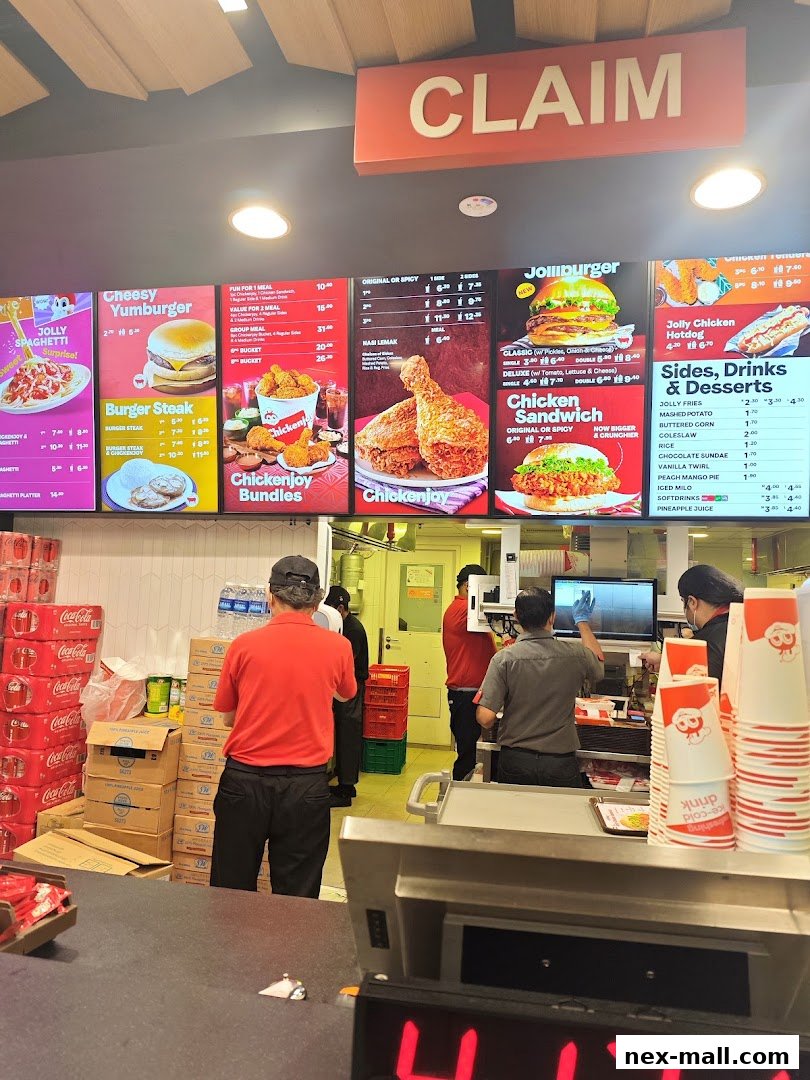 A Jollibee menu board displaying various food items like spaghetti, burgers, chicken, and sides.