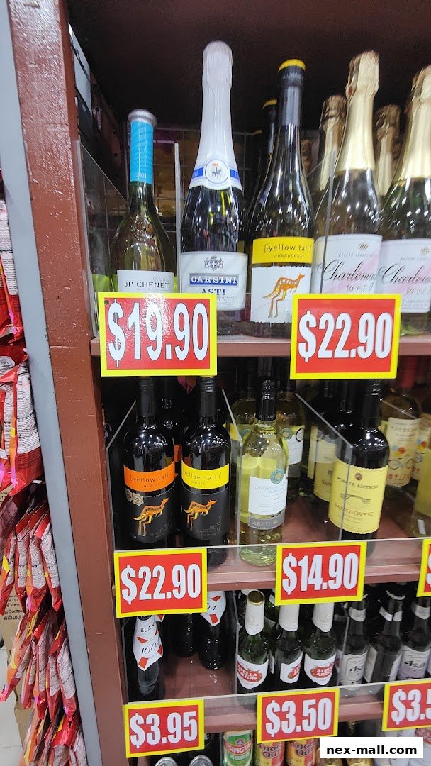 A display of various wine and beer bottles with price tags.