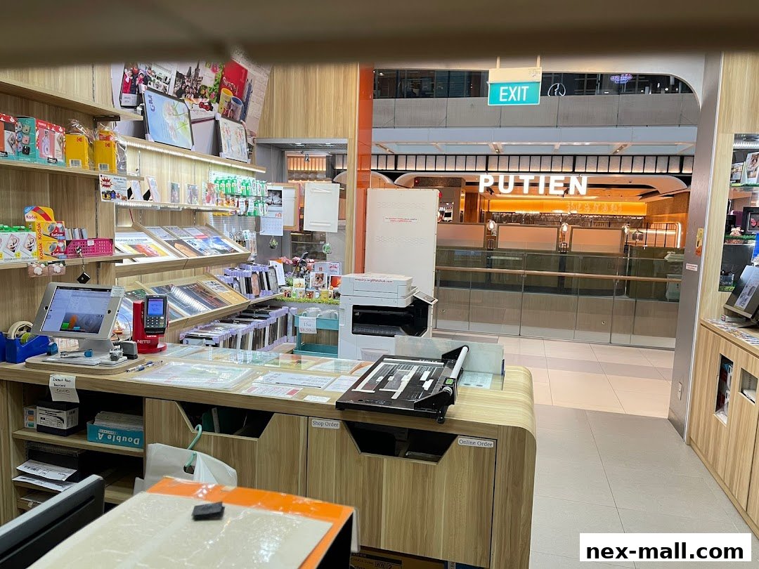 Interior view of a photo printing and services shop with displays of products and a counter.