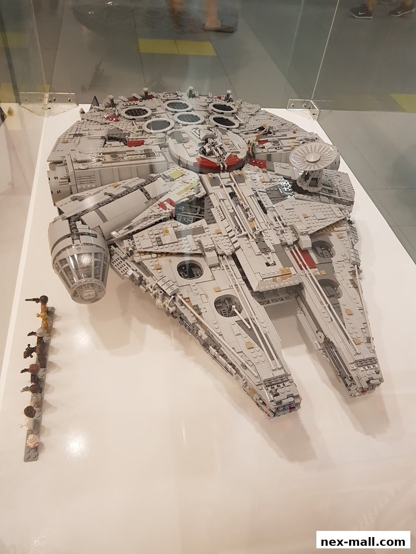 A detailed LEGO Millennium Falcon model with minifigures displayed.