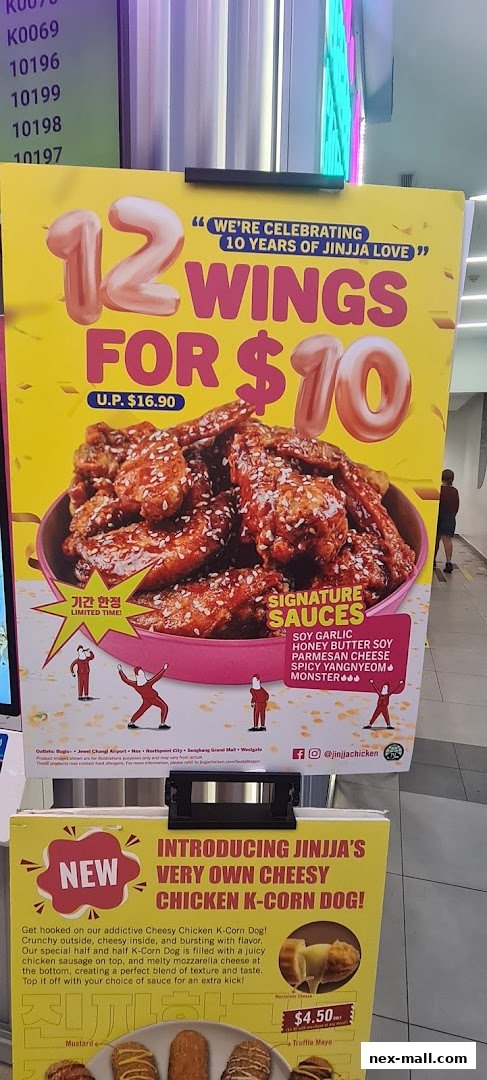 A promotional poster for JINJJA Chicken featuring a 12-wing deal and a new Cheesy Chicken K-Corn Dog.