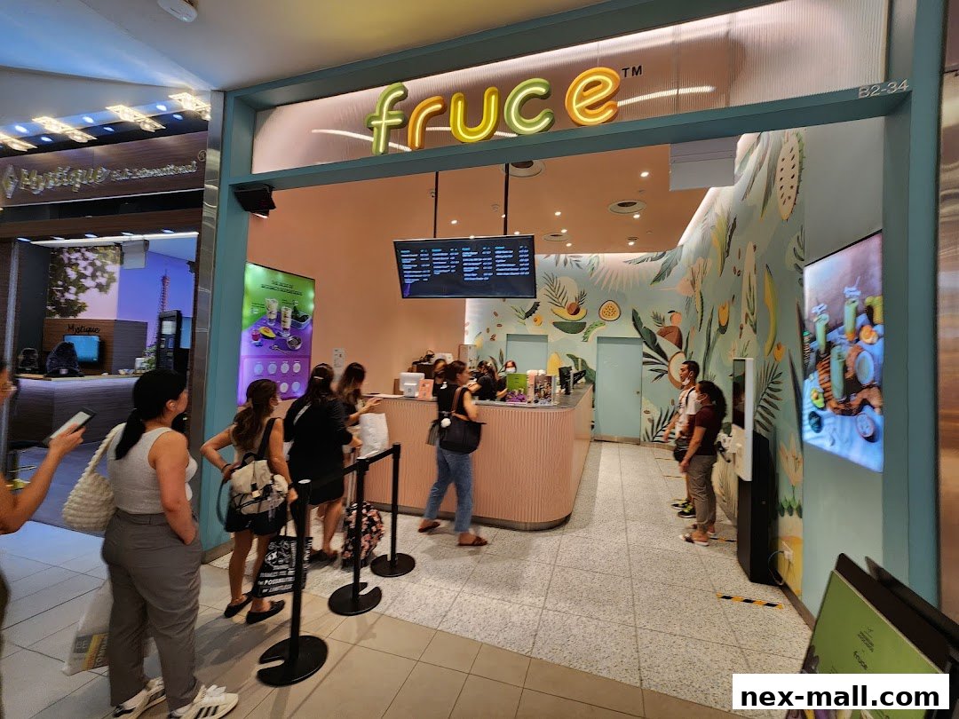 A juice bar with a colorful mural and customers queuing at the counter.