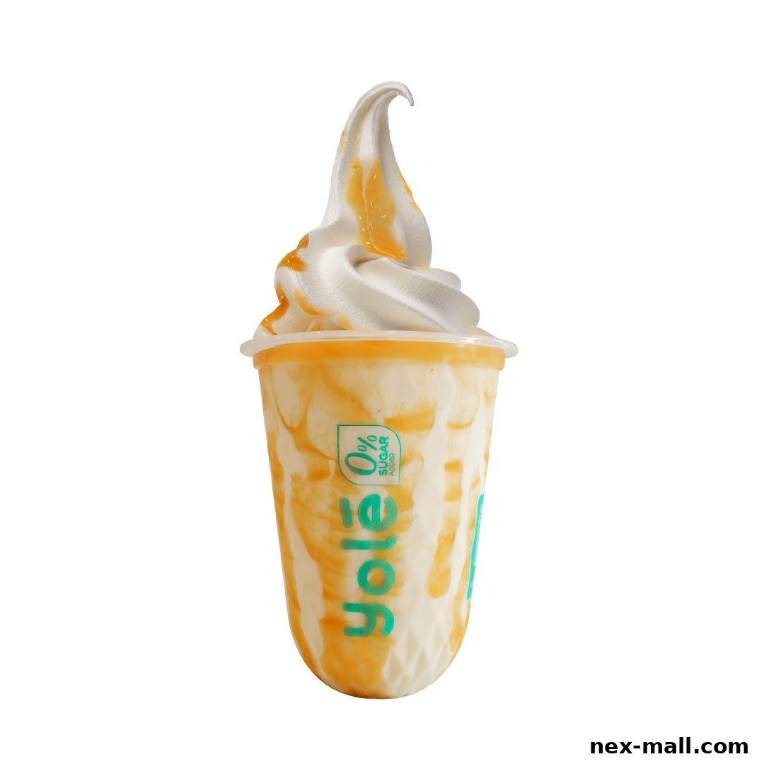 A delicious swirl of soft-serve ice cream with caramel sauce in a Yolé cup.