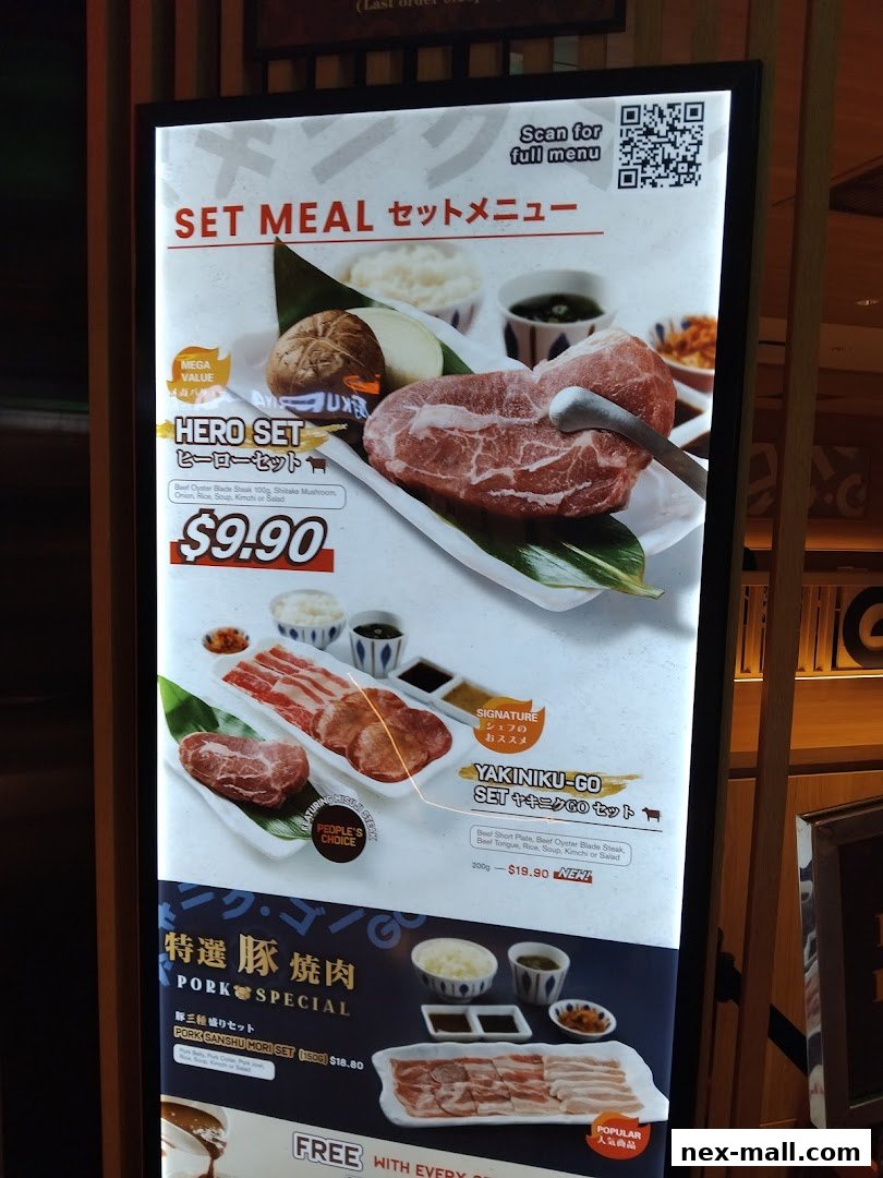 A brightly lit menu board showcasing Yakiniku set meals with various meat options and prices.