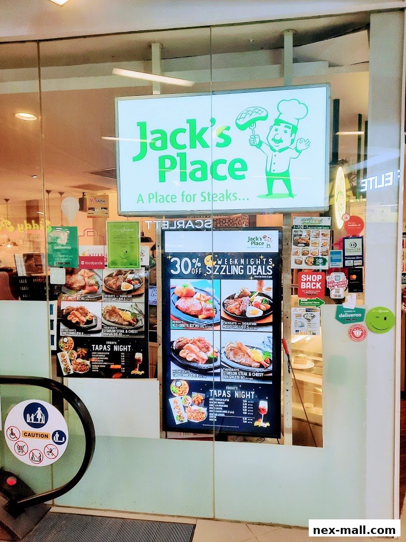 The entrance of Jack's Place restaurant with a menu board displaying steak deals and tapas night.