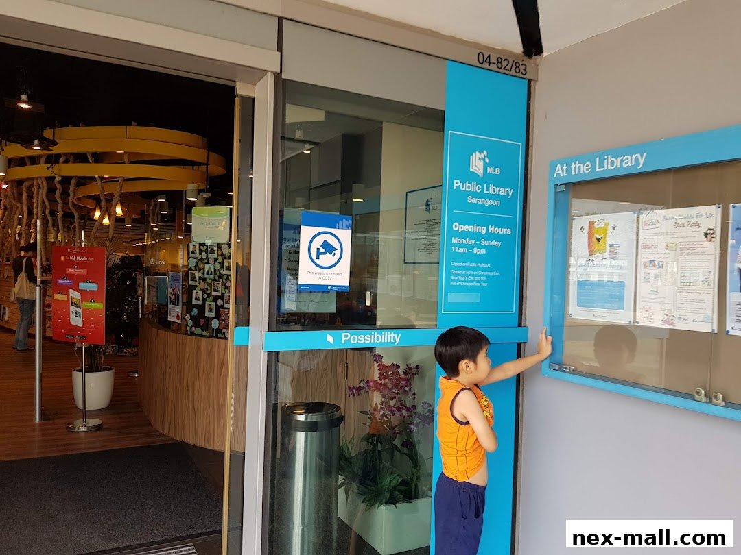 Entrance to Serangoon Public Library with a child looking at a display board.