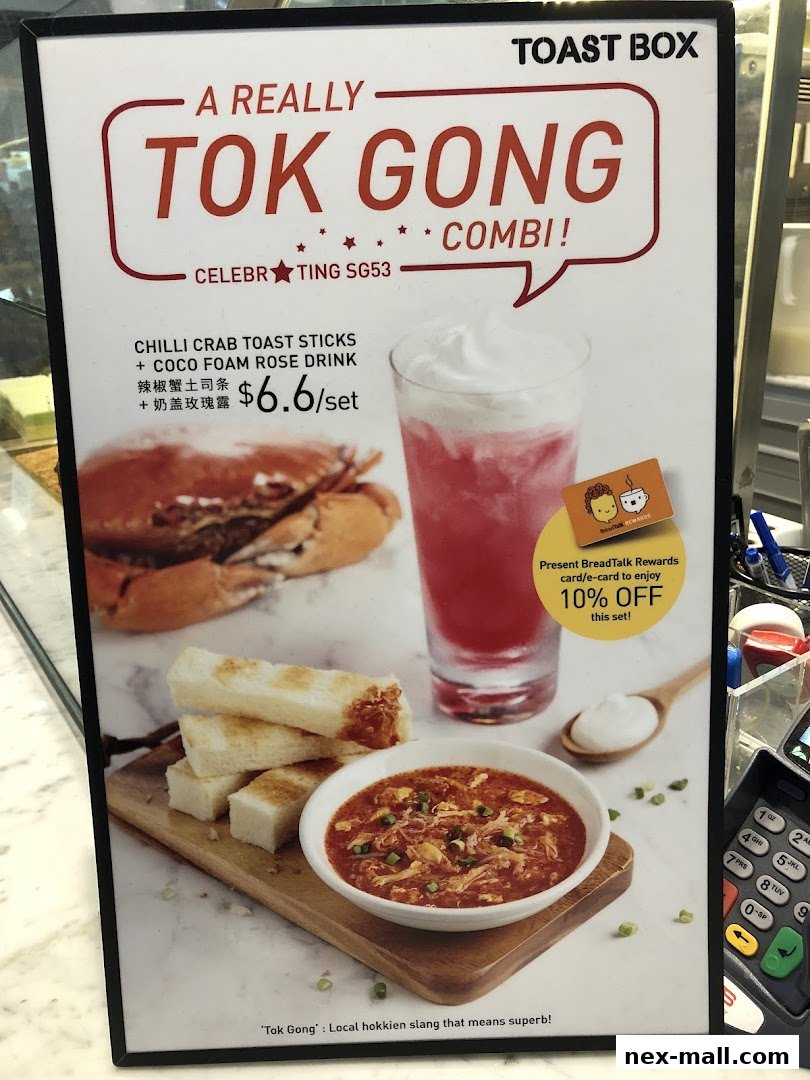 A promotional sign for Toast Box featuring a Chilli Crab Toast Sticks and Coco Foam Rose Drink combo.