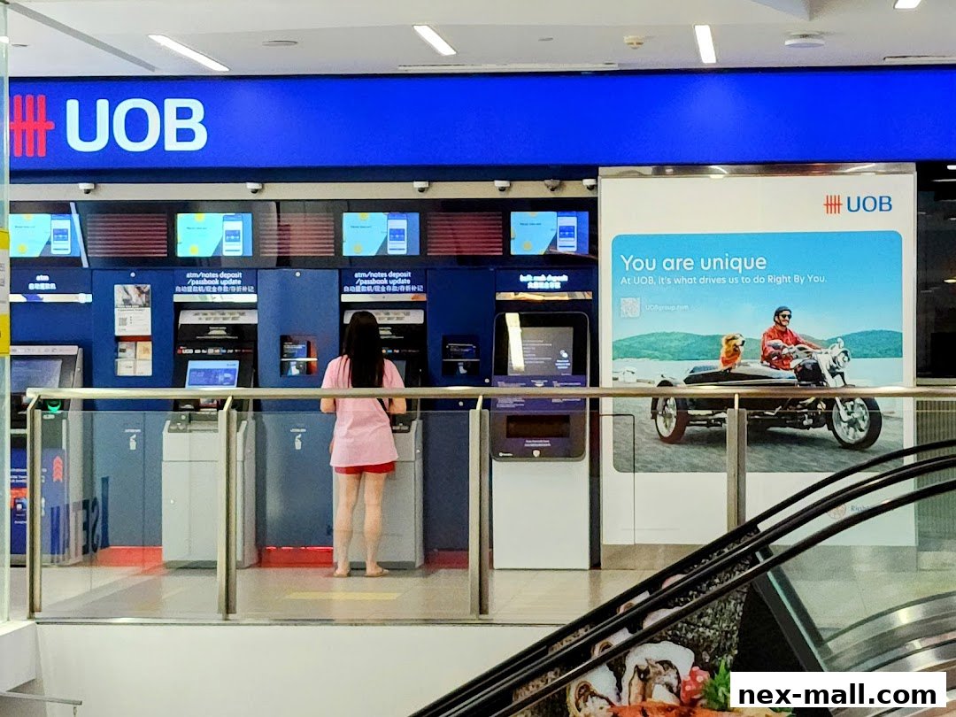 A UOB bank branch with ATMs and a promotional poster featuring a man and a dog on a motorcycle.