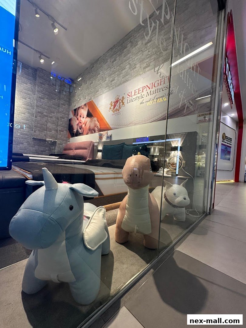 A shop window display featuring mattresses and plush animal toys.