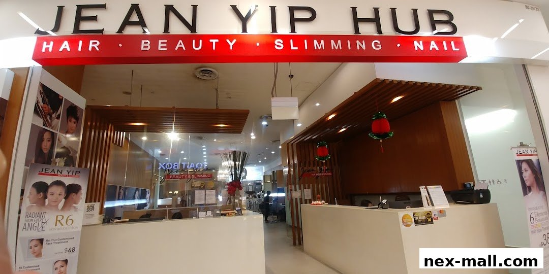 The entrance of Jean Yip Hairdressing NEX, showcasing their services and branding.