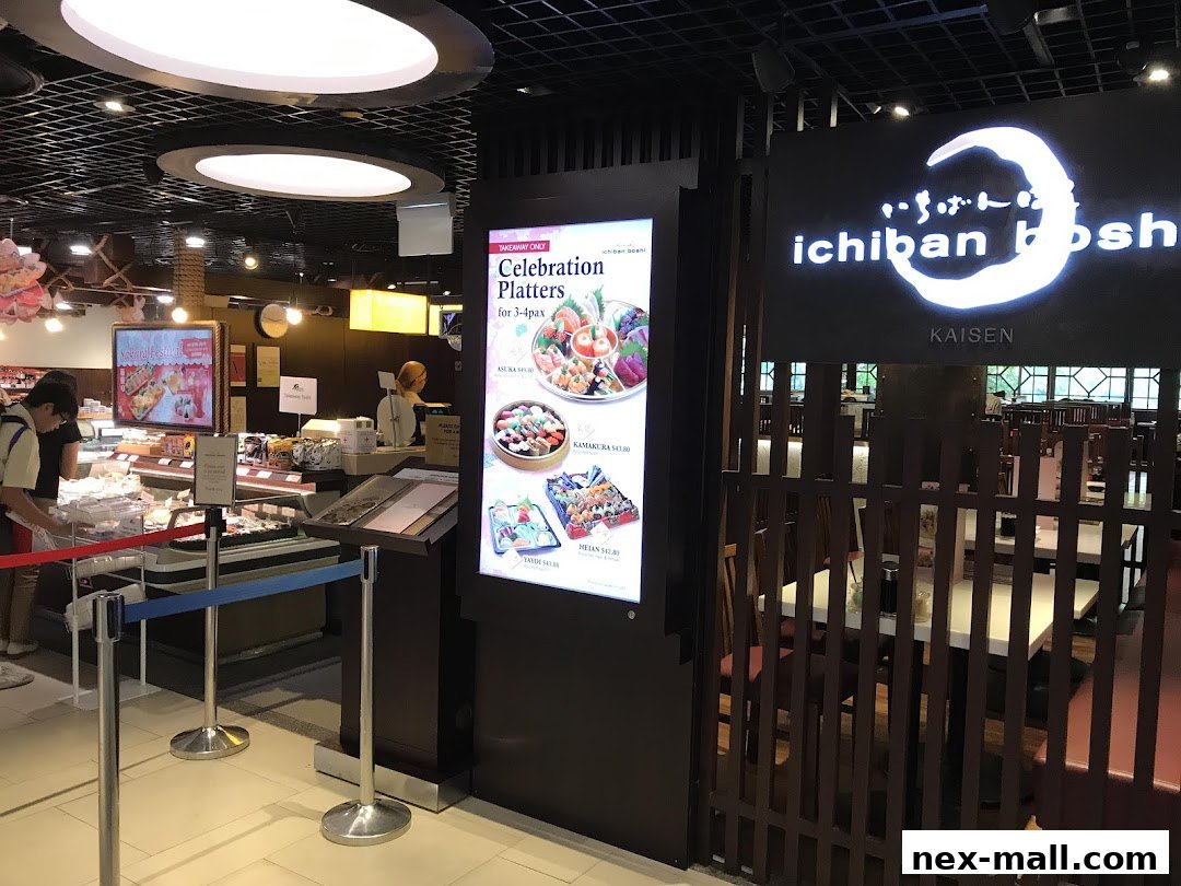 The entrance to Ichiban Boshi NEX, featuring a illuminated menu and seating area.