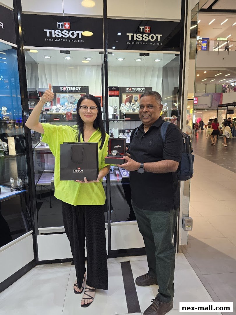 A woman and a man stand in front of a Tissot watch store, holding a shopping bag and a watch box.