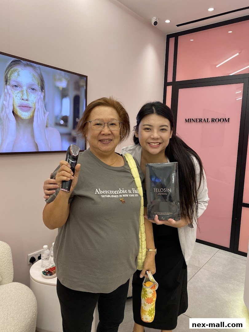 Two women smiling in a bright, modern salon, holding beauty products.