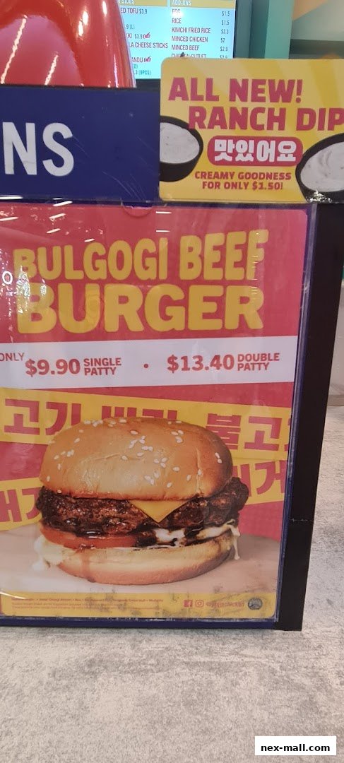 A close-up of a Bulgogi Beef Burger with prices for single and double patties.
