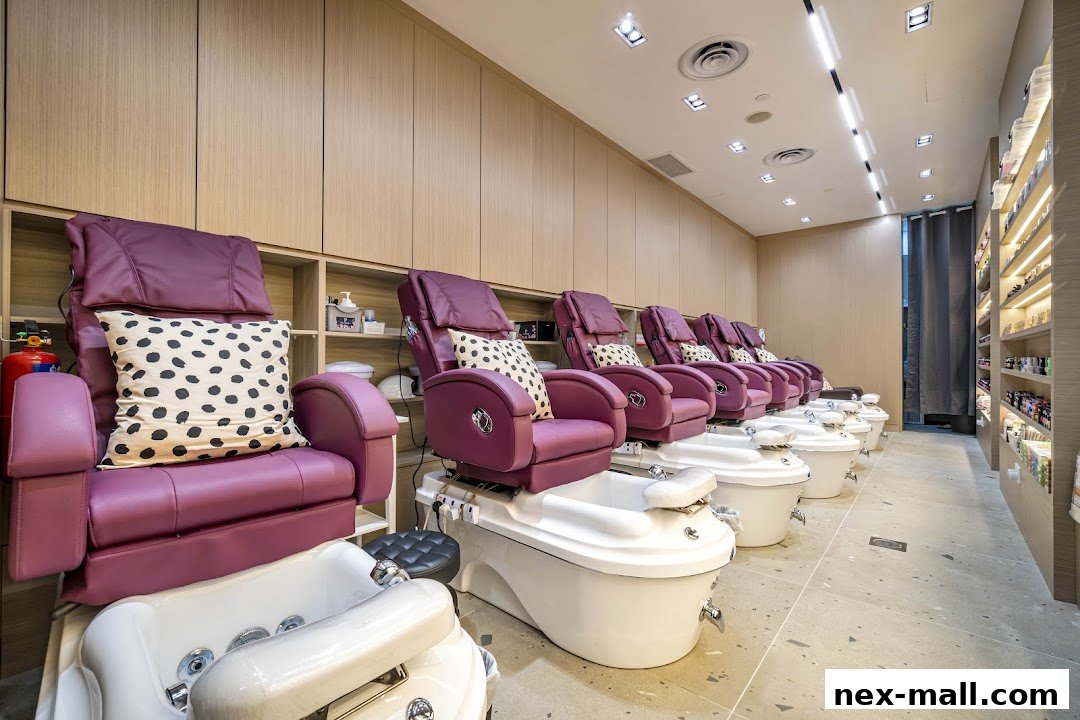 A row of luxurious purple pedicure chairs with foot baths in a clean, modern nail spa.