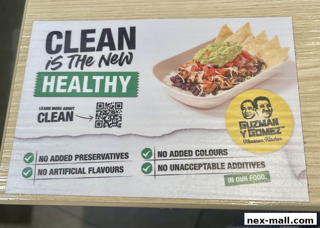 A sign promoting Guzman y Gomez's commitment to clean and healthy food with a picture of their Mexican cuisine.