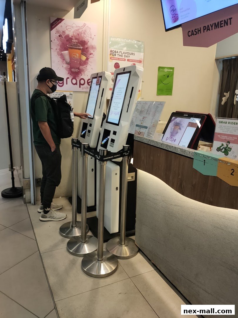 A customer uses a self-order kiosk at a PlayMade bubble tea shop.