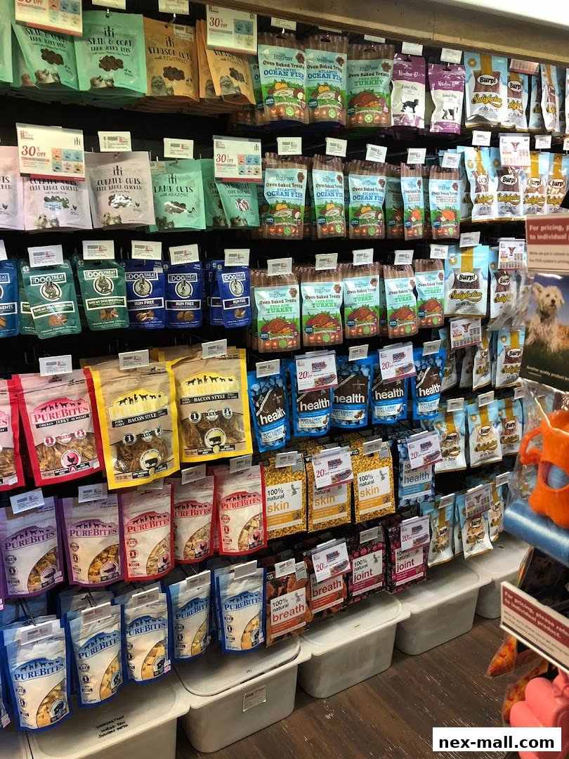 A wide selection of pet treats and food products displayed on shelves.