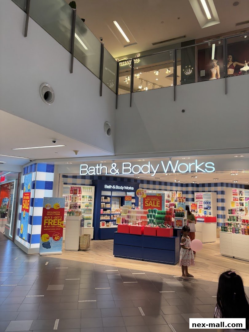 The Bath & Body Works store entrance with displays of scented products and sale signs.