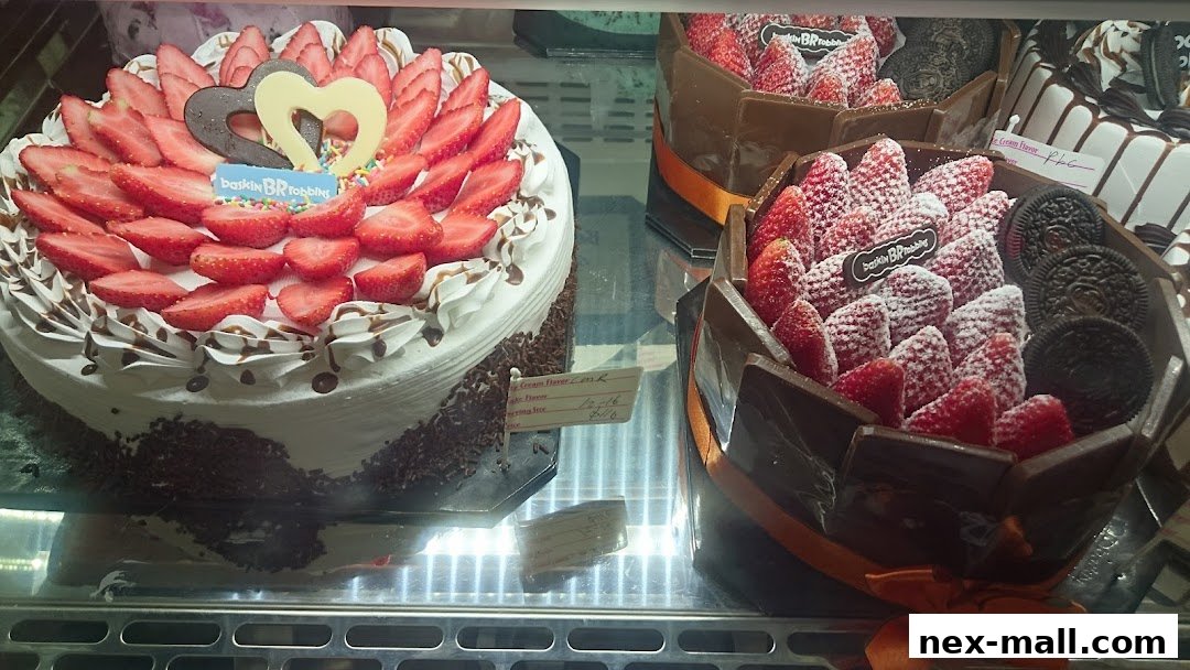 Baskin-Robbins ice cream cakes decorated with fresh strawberries and chocolate.