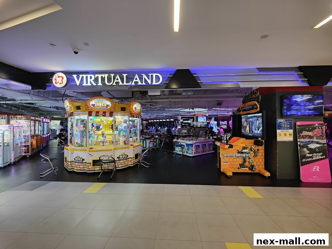 Interior view of Virtualand arcade with various game machines and a large claw machine.