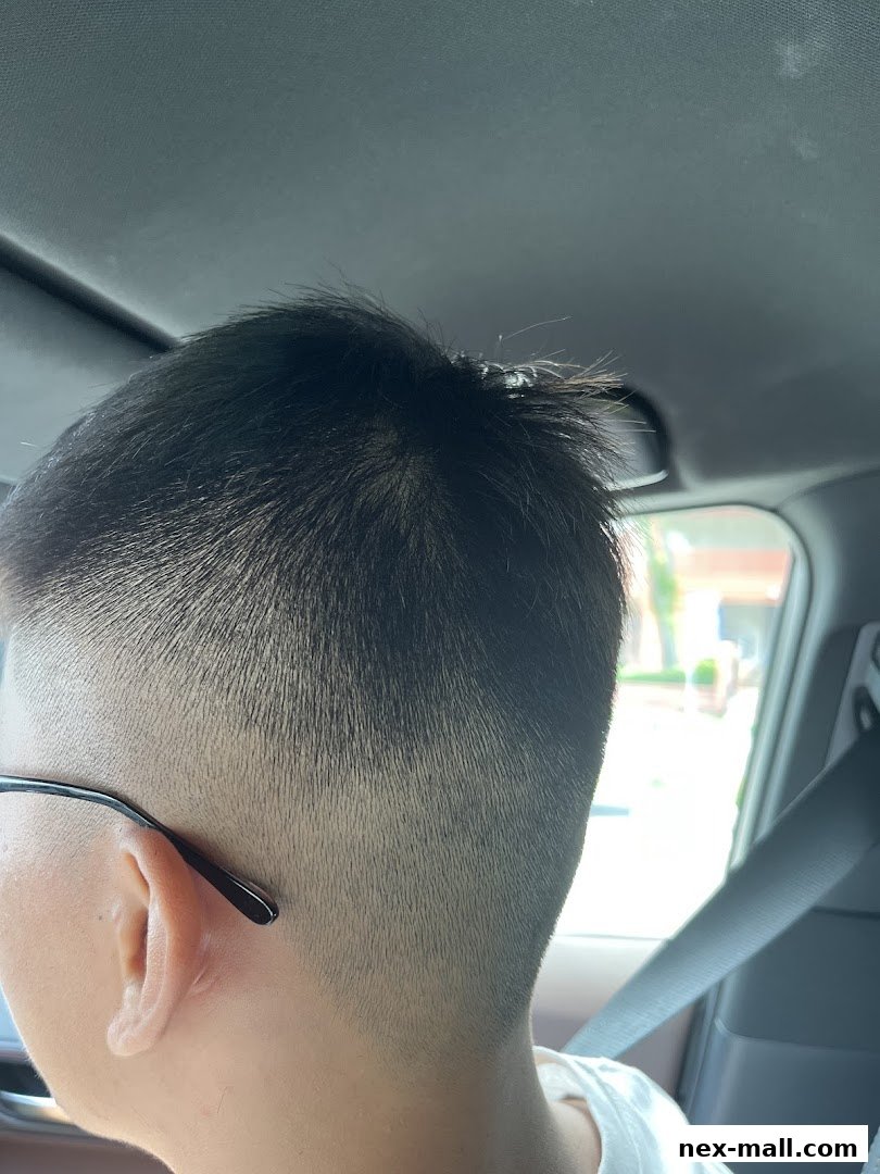 Close-up of a person's freshly cut hair, showing a fade haircut.
