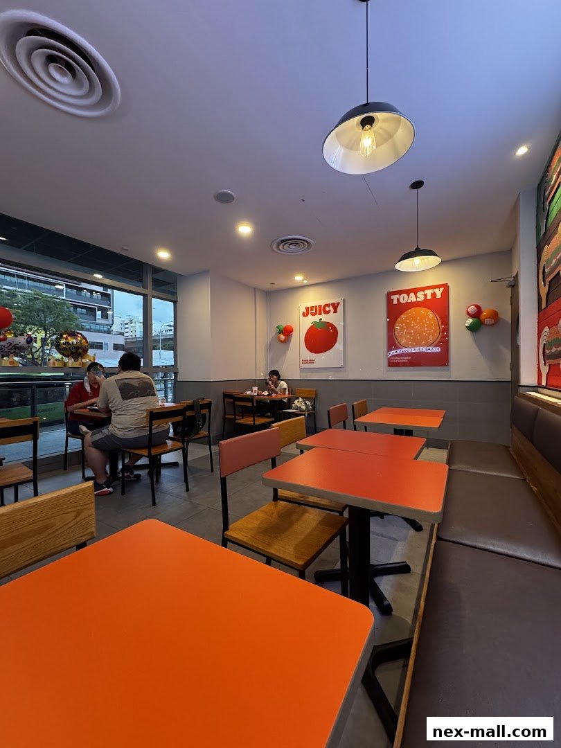 Interior of a Burger King restaurant with orange tables and seating.