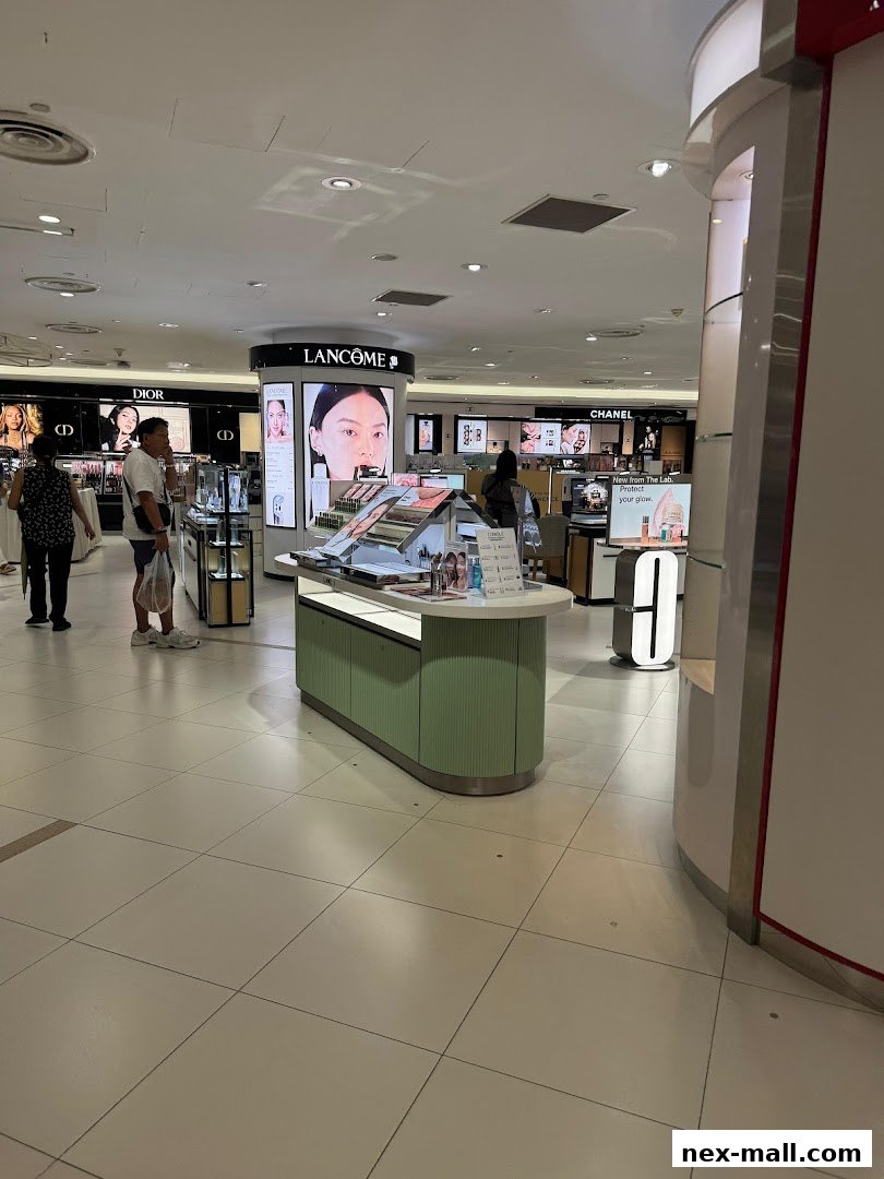 Interior view of a beauty department store with various cosmetic brands displayed.