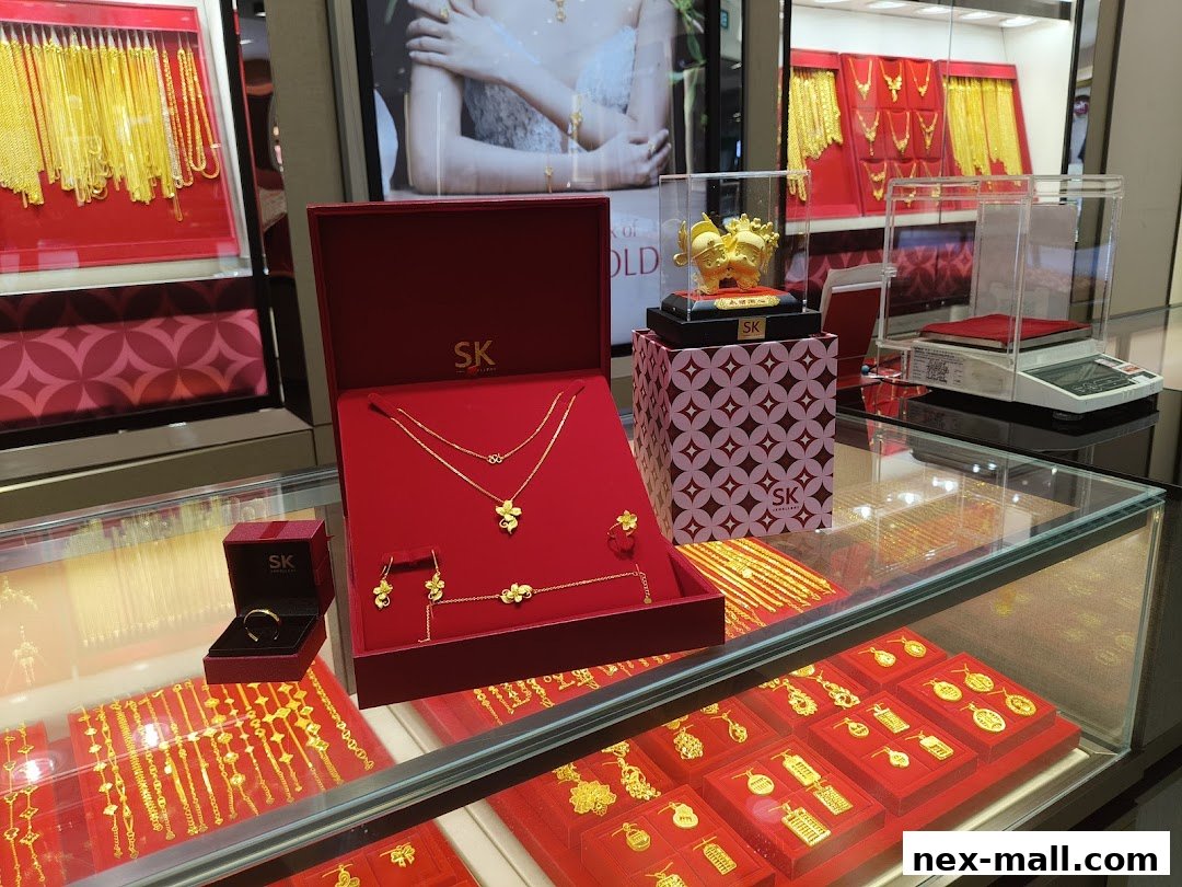 SK Jewellery NEX shop display featuring gold necklaces, bracelets, earrings, and a jewelry set.
