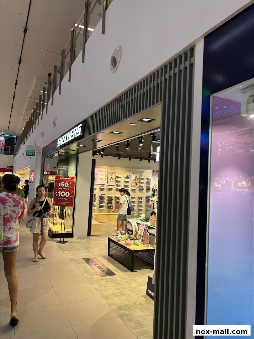 The Skechers NEX store entrance with shoes displayed and a promotional sign.