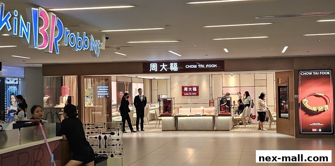 Chow Tai Fook Jewellery store entrance with displays and customers inside.