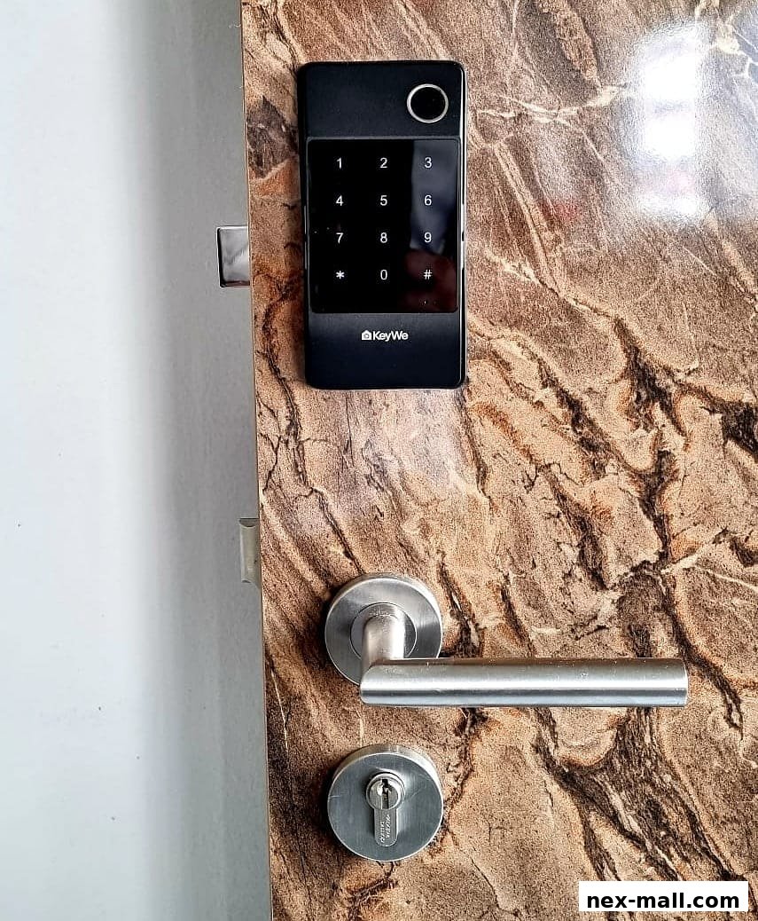 A close-up of a modern digital door lock with a keypad and fingerprint scanner.