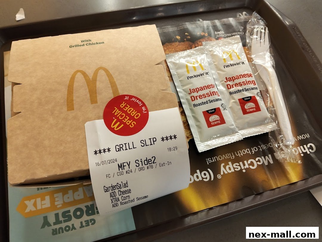 A McDonald's meal with a grilled chicken box, salad, and Japanese dressing packets.