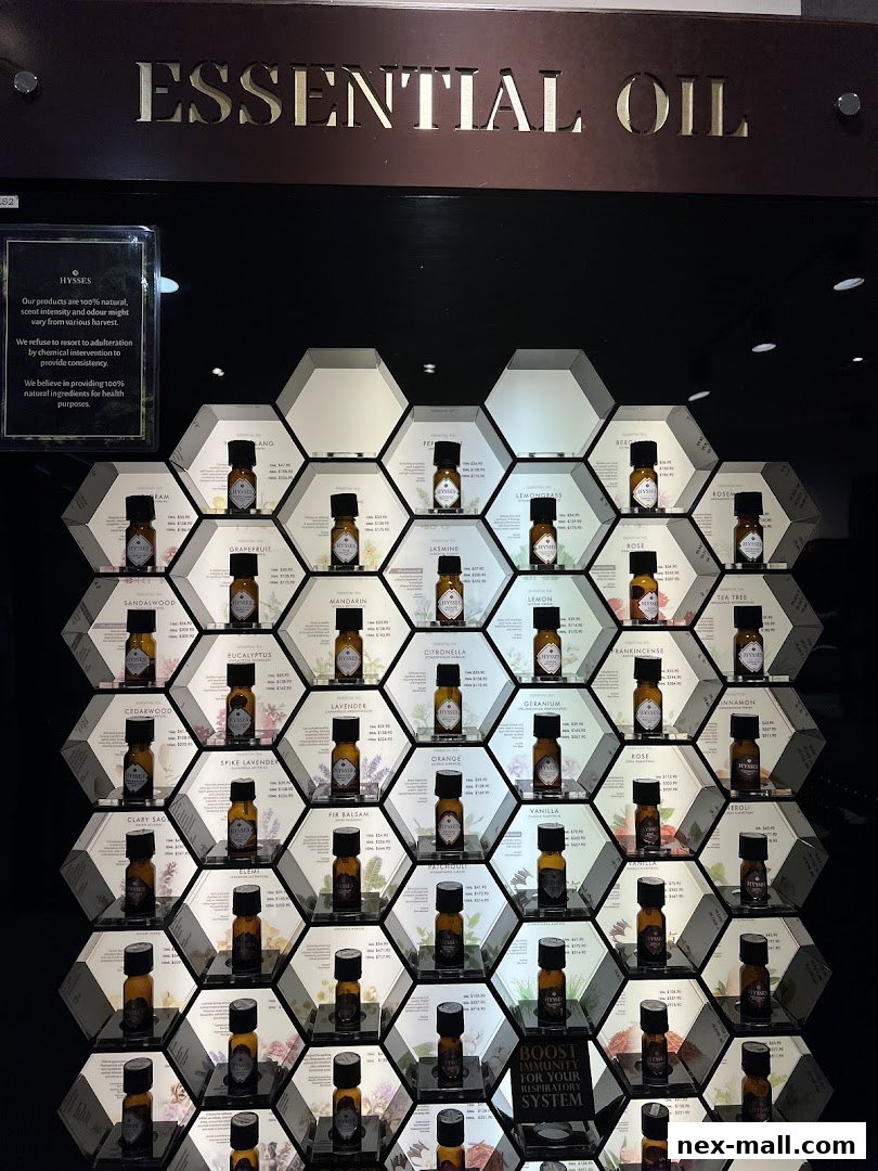 A display of essential oil bottles arranged in a honeycomb pattern with product information.