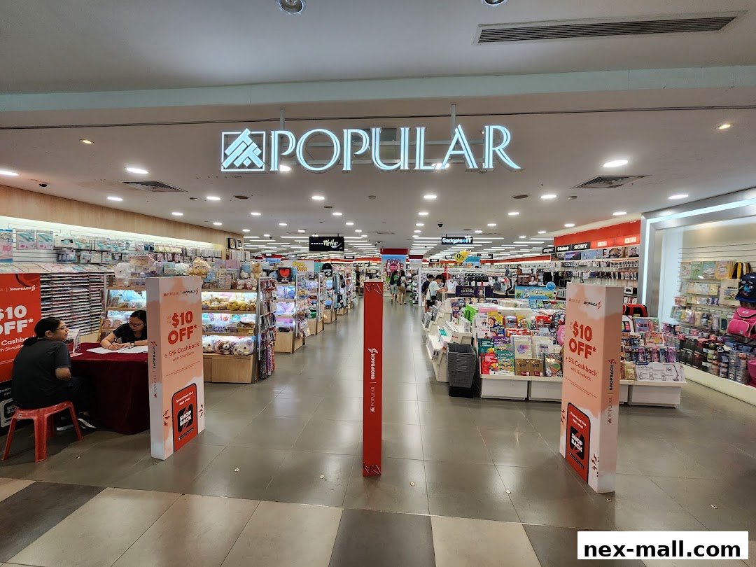 The entrance to a POPULAR bookstore, showcasing shelves filled with books and merchandise.