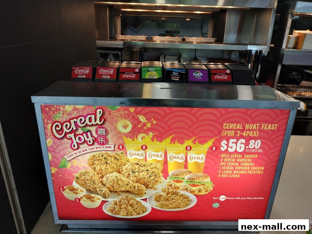 A promotional display for Texas Chicken's Cereal Huat Feast, featuring fried chicken, burgers, and drinks.
