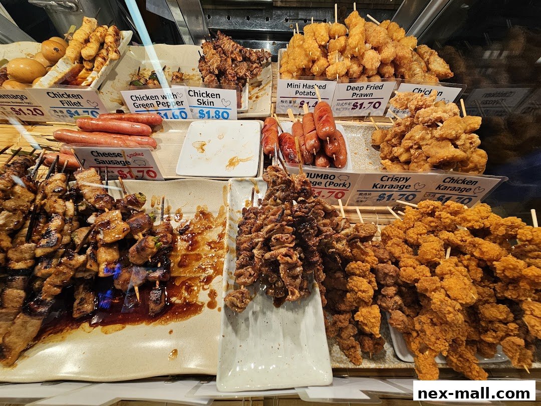 A display of various Japanese-style skewers and fried snacks with price labels.