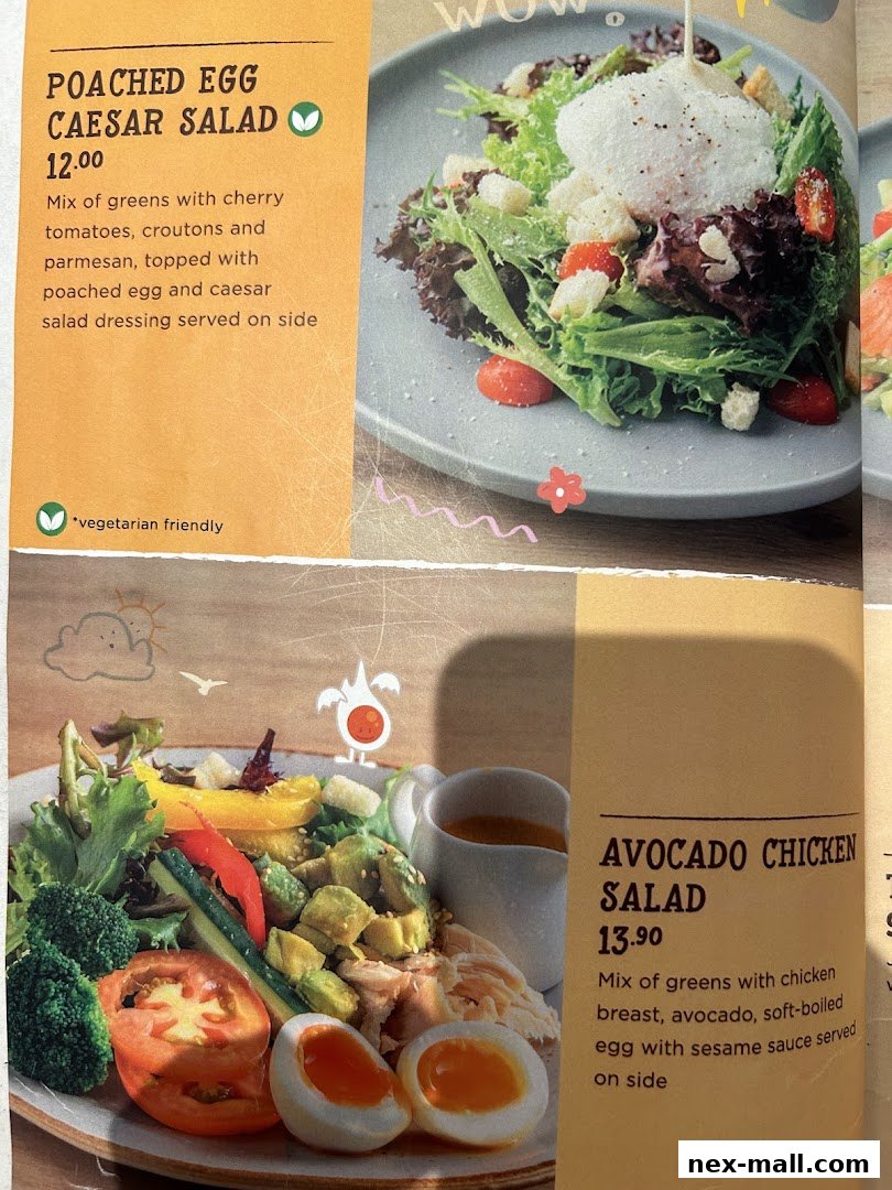 A menu featuring two salads: Poached Egg Caesar Salad and Avocado Chicken Salad.