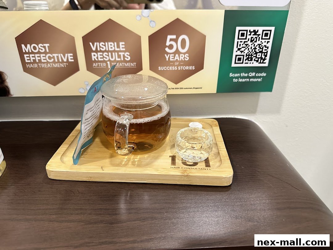 A welcome drink of tea and a small glass on a wooden tray at Beijing 101 Hair Consultants.